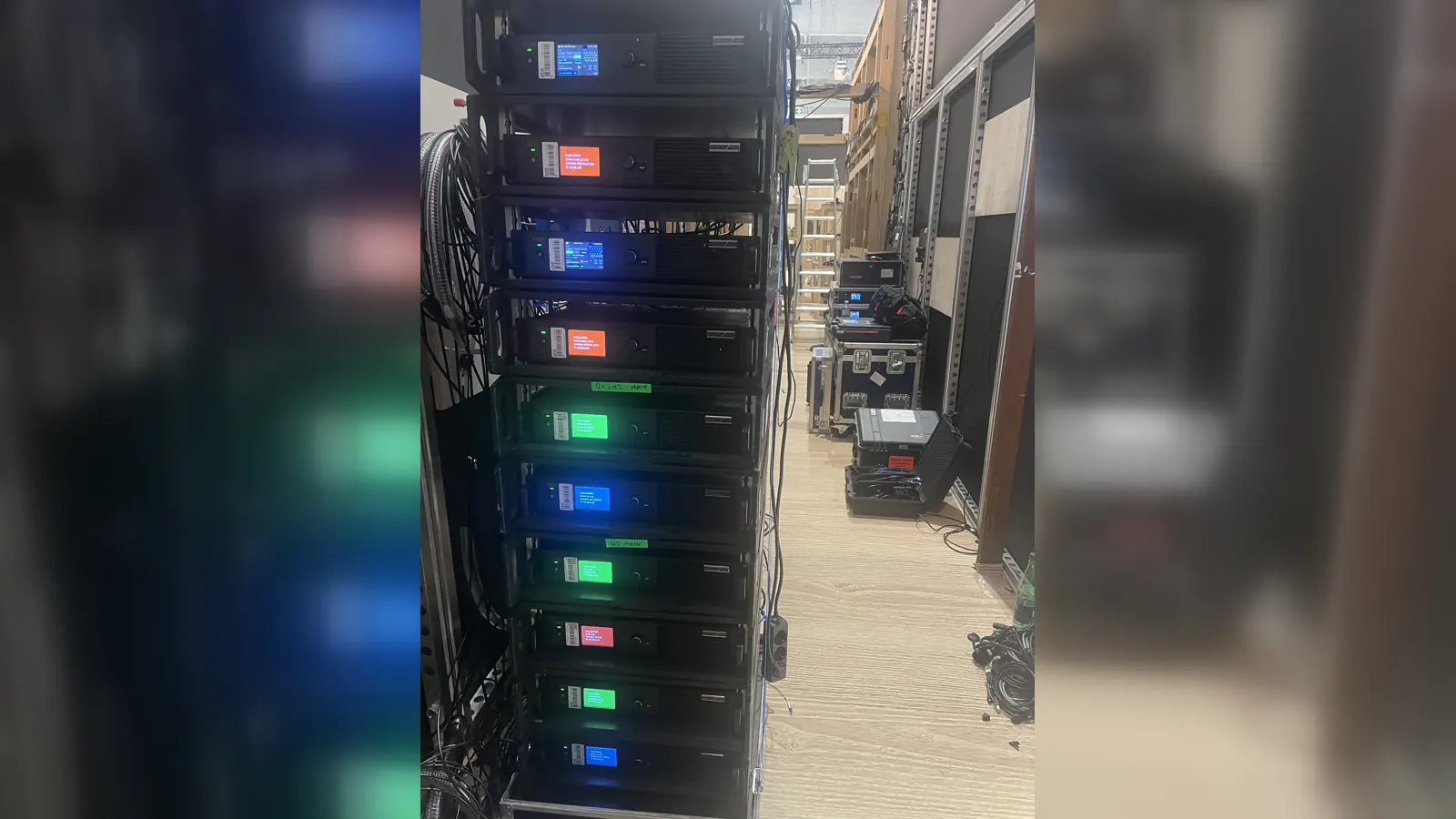 Event LED processing racks installed behind a large LED wall